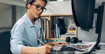 Woman working at her desk taking notes